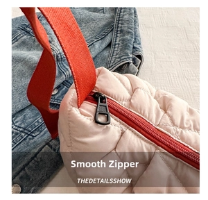 Macro shot of smooth black metal zipper and quilted nylon fabric on a winter tote bag
