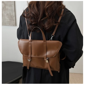Rear view of a model wearing a brown vintage leather multi-functional tote backpack