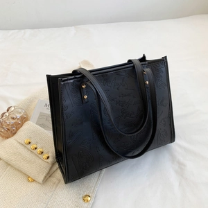 Large black graffiti embossed tote bag for women in a chic urban commuter style