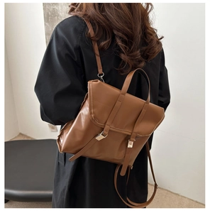 Rear view of a model wearing the brown vintage leather backpack with adjustable straps