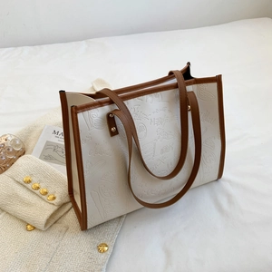 Large beige tote bag with brown trim and embossed love graffiti for stylish daily commute