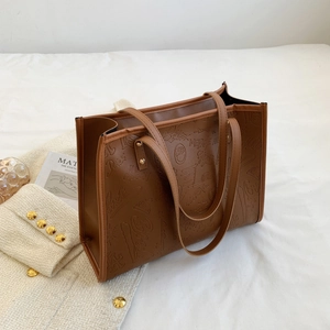 Brown large capacity leather tote bag with stylish graffiti embossing and shoulder straps