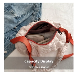 Detail view of the quilted tote bag open interior showing large capacity and orange strap