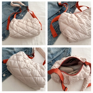 Detailed macro view of quilted diamond pattern and interior pocket of a crossbody bag