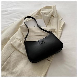 Detail of a vintage black matte leather underarm bag with decorative square buckle