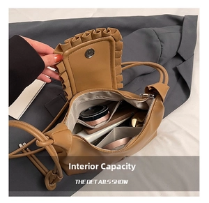 Detail view of the drawstring cloud bag interior holding a smartphone and cosmetics