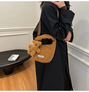 Close-up of caramel plush faux fur bucket bag featuring a cute bear charm and clear tag