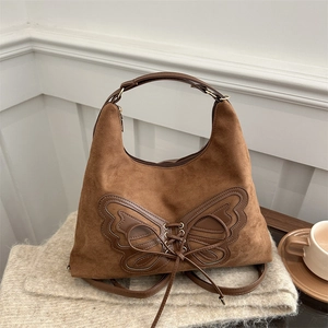 Sac fourre-tout vintage en daim marron avec design papillon et laçage en cuir chic