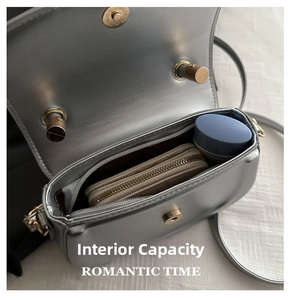 Internal capacity of the silver saddle bag showing space for wallet and cosmetics