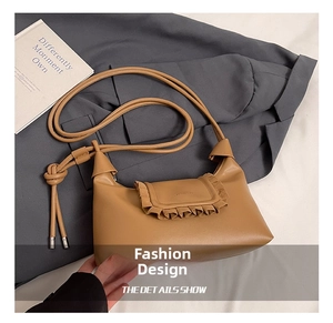 Detail view of khaki leather cloud bag featuring elegant drawstring frill and slim knot strap