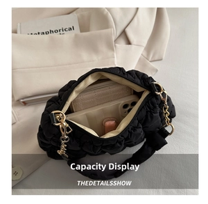 Interior view of black quilted cloud bag with gold chain showing spacious capacity