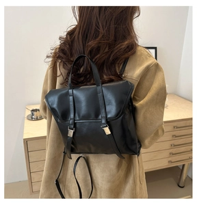 Rear view of model wearing a vintage black PU leather multi-functional backpack and tote