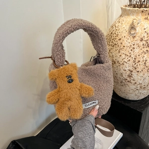Chic winter taupe faux fur bucket bag with plush bear charm and crossbody strap