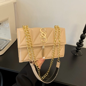 Quilted beige shoulder bag with gold metal logo, fringe detail, and chain strap
