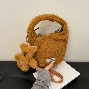Brown faux fur bucket bag with plush bear charm and CLEAR logo for winter fashion