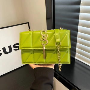 Quilted lime green square crossbody bag with gold chain strap and stylish tassel detail