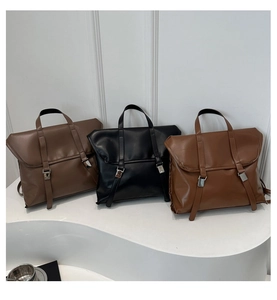 Three vintage leather backpacks in dark brown, black, and caramel with double buckle straps
