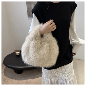 Detail of soft beige faux fur handbag with plush handle for winter casual outfits