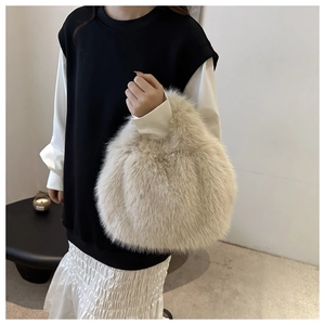 Close-up of soft light beige faux fur handbag with a plush texture for winter fashion