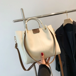 Cream white PU leather tote bag with brown straps and golden metal hardware handle