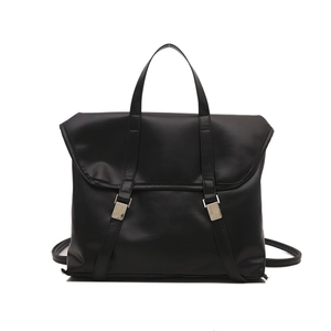 Matte black versatile tote backpack with dual silver buckle straps on white background