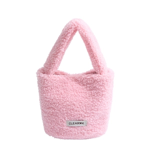 Pink plush lamb wool bucket bag with top handle and woven brand label for autumn winter