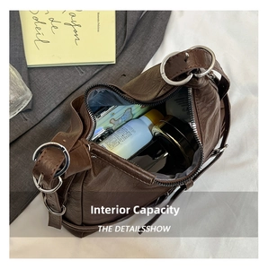 Detail of the brown crescent bag interior showing spacious storage for cosmetics