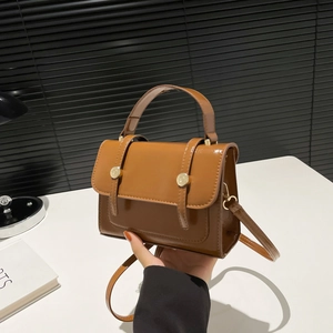 Brown patent leather small square bag with top handle and gold decorative buttons