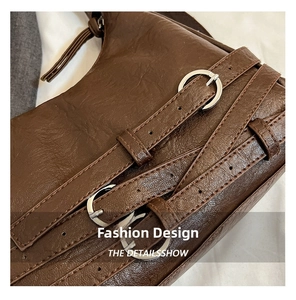 Detail showing vintage litchi grain dark brown leather and silver metal buckles
