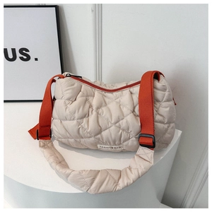Detail of beige quilted puffer bag with orange nylon strap and Fashion Bag logo
