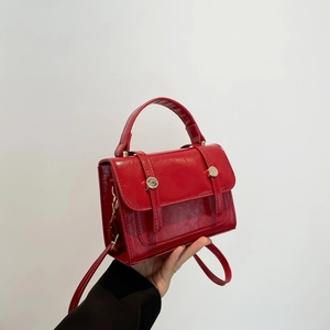 Retro red leather handbag for women featuring top handle and silver buckle detail