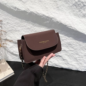 Sac à bandoulière carré en cuir marron foncé avec chaîne dorée et logo chic