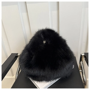 Detail of premium black faux fur texture on a fluffy winter hat showing soft long plush fibers
