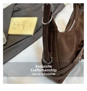 Close-up of dark brown vintage texture leather underarm bag with silver ring detail