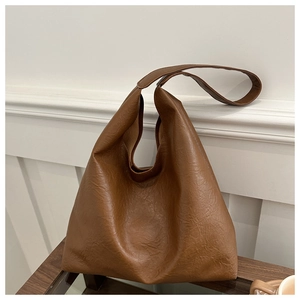 Detailed view of the soft vintage brown faux leather texture on the large tote shoulder bag