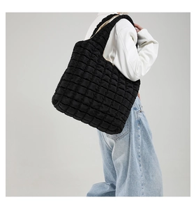 Detail view of the black quilted puffer tote bag with soft padded straps and large capacity