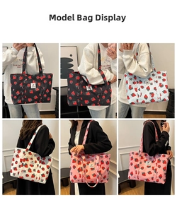 Detail view of strawberry print canvas tote bag in black white blue and pink colors