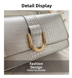 Macro shot of silver crocodile pattern faux leather and gold U-shaped metal buckle