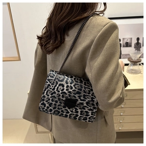Leopard print crossbody bag with chain strap styled on a khaki blazer for chic fashion look