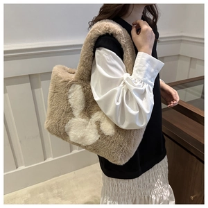 Detailed view of a plush tote bag with a white rabbit silhouette for autumn and winter