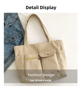 Detailed close-up of beige tote bag with functional pockets and premium hardware