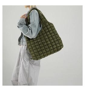 Detail of olive green quilted bubble tote bag with pleated diamond lattice texture