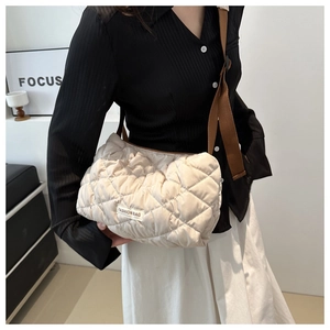 Quilted off-white puffer tote bag with brown shoulder strap and fashion label detail