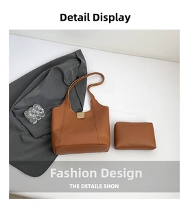 Detail view of brown leather tote bag set with matching zippered pouch and gold metal hardware