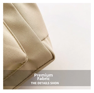 Detail shot of the beige woven canvas tote bag showing stitching and fabric texture