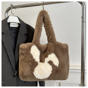 Detailed view of the soft brown plush tote bag with a cute white bunny patch design