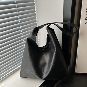 Large black leather tote bag for women with a vintage minimalist shoulder design