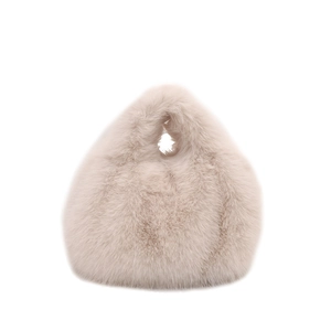 Plush faux fur handbag in beige featuring a soft furry texture and a round handle cutout
