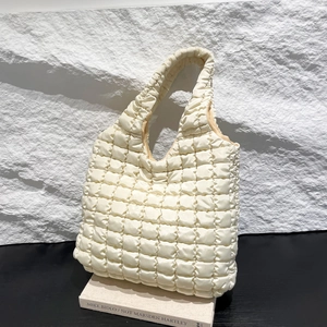 Stylish off-white quilted puffer tote bag with a minimalist puffy cloud texture design