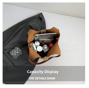 Top view showing the large internal capacity of the brown tote bag with various daily items